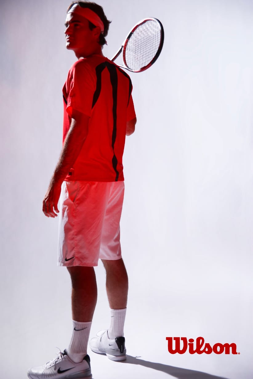 Wilson advertisement: a tennis player in red and white seen from behind, racket over his shoulder.