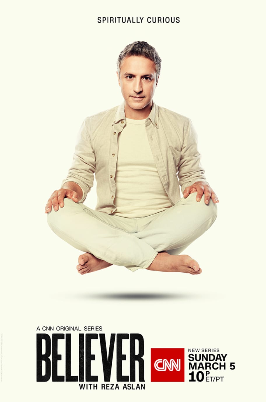 Poster for the CNN series Believer with Reza Aslan, a man in cream clothes sitting cross-legged in mid-air.